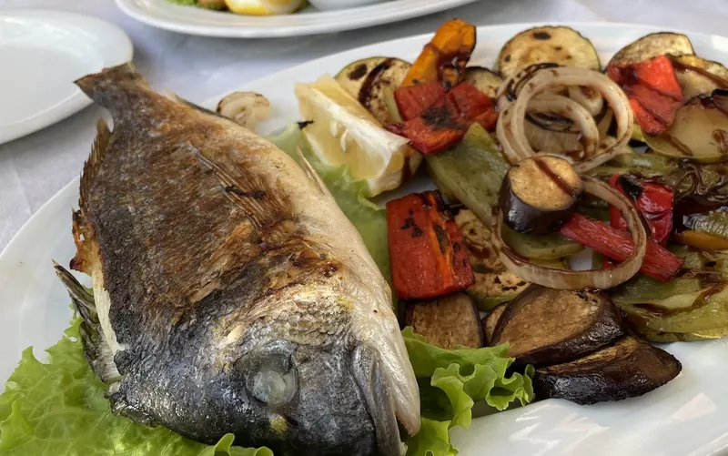 Grilled orata with grilled vegetables, fried shrimps behind