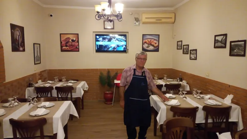 The dining room set for dinner, with a member of staff at the tables